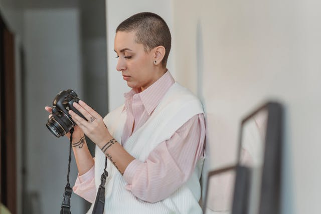 Person looking at a camera while holding it